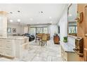 Inviting living room featuring stone floors, comfortable seating, and natural light from sliding glass doors at 36750 Us 19 N # 06111, Palm Harbor, FL 34684