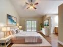The main bedroom features a king bed, sliding glass doors, ceiling fan, and ensuite bathroom at 3810 Hollister Pl, Brandon, FL 33511