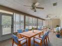 A cozy sun room features tile flooring, lots of windows, and comfortable furniture at 3810 Hollister Pl, Brandon, FL 33511