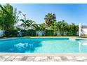 Refreshing pool with lush landscaping, privacy fence, and plenty of sunshine for outdoor enjoyment at 4104 W Watrous Ave, Tampa, FL 33629