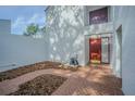 Inviting front entrance features a brick-paved patio and a solid red door at 4137 Northmeadow Cir, Tampa, FL 33618