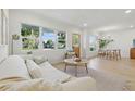 Spacious living area with ample natural light, modern furnishings, and a view into the dining space at 4219 26Th N Ave, St Petersburg, FL 33713