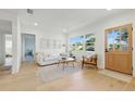 Cozy living room with white couch, natural light, and light hardwood floors, creating a welcoming and serene atmosphere at 4219 26Th N Ave, St Petersburg, FL 33713
