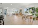 Bright, airy living room with modern decor, hardwood floors, and large windows showcasing the exterior landscape at 4219 26Th N Ave, St Petersburg, FL 33713