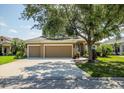 A beautiful, single-story home with a three-car garage and mature landscaping at 4410 Natures Reach Ter, Parrish, FL 34219