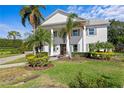 A beautiful two-story home featuring a classic facade with stately columns and walkway at 4935 W Bay Way Pl, Tampa, FL 33629
