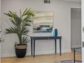 Inviting entryway with stylish console table, artwork, and decorative plant for a welcoming ambiance at 506 71St Ave # 7, St Pete Beach, FL 33706