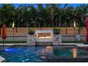 Backyard pool and spa with a water feature and lush landscaping offering a private tropical oasis at 6129 Leeland S St, St Petersburg, FL 33715