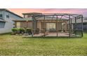 Relaxing screened patio with a BBQ, outdoor seating, and a spacious lawn at 7815 Blue Spring Dr, Land O Lakes, FL 34637