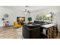 Bright and inviting living room featuring a large sectional sofa and modern decor at 914 Woodland Dr, Palm Harbor, FL 34683