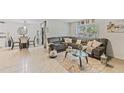 Inviting living room featuring a comfortable gray sectional sofa and a dining area with tile flooring at 10463 Baylor Dr, Spring Hill, FL 34608