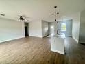 Bright, open-concept living room featuring modern island kitchen with elegant pendant lighting at 12219 Bacchus Rd, Port Charlotte, FL 33981