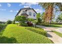A well-maintained lawn surrounds this charming two-story residence at 1341 Marinella Dr, Palm Harbor, FL 34683
