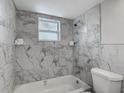 Bathroom with a tub and tiled walls at 1408 Maybury Dr, Holiday, FL 34691