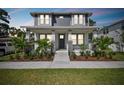 Inviting two-story home with well-maintained landscaping and a cozy front porch at 1522 W Arch St, Tampa, FL 33607