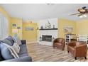 Bright living room with hardwood floors, a cozy fireplace, and comfortable seating at 1560 Simmons Dr, Clearwater, FL 33756