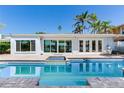 A refreshing pool and patio area, perfect for enjoying sunny days and outdoor relaxation with waterfront views at 16353 Redington Dr, Redington Beach, FL 33708