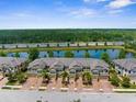 Aerial view of townhomes showcasing the community's prime waterfront location and lush surroundings at 1969 Milkweed Trce, Lutz, FL 33558