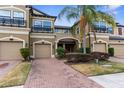 Charming townhome featuring a brick drive, two-car garage, and well-maintained landscaping at 1969 Milkweed Trce, Lutz, FL 33558