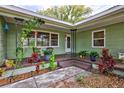 Cozy covered front porch with stylish decor, plants, and seating area at 1984 Trotter Rd, Largo, FL 33774