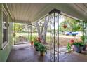 Inviting porch with a swing, foliage, and views of the surrounding area at 1984 Trotter Rd, Largo, FL 33774