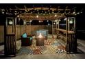 Cozy pergola featuring stylish seating, a fire pit, and decorative lighting for evening relaxation at 22396 Nyack Ave, Port Charlotte, FL 33952