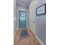 Foyer with custom glass paneled door and neutral walls and tile at 2674 Tanglewood Trl, Palm Harbor, FL 34685