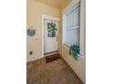 Welcoming front porch with ceramic tile and custom storm door at 2674 Tanglewood Trl, Palm Harbor, FL 34685