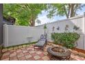 Serene backyard with a patio, seating, firepit, and privacy fence, perfect for relaxation at 2811 S Pines Dr # 15, Largo, FL 33771