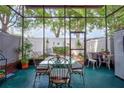 Enclosed sunroom featuring ample seating and natural light with views of the backyard at 2811 S Pines Dr # 15, Largo, FL 33771