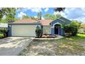 Charming single-story home with a well-maintained lawn and a two-car garage at 28818 Midnight Star Loop, Wesley Chapel, FL 33543