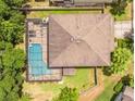 Aerial view of a private backyard oasis with a sparkling swimming pool enclosed by a screened-in lanai at 309 Dakota Hill Dr, Seffner, FL 33584