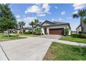 Single-Gathering home with a two-car garage, brick driveway, and neatly maintained landscaping at 31637 Cannon Rush Dr, San Antonio, FL 33576