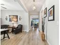 Stylish hallway with wood-look floors and a view of the living area at 31637 Cannon Rush Dr, San Antonio, FL 33576