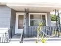 Close-up of a charming front porch with decorative iron railings, offering a warm welcome at 3253 57Th N Ave, St Petersburg, FL 33714