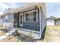 Charming home's front porch features decorative black iron railings, enhancing curb appeal at 3253 57Th N Ave, St Petersburg, FL 33714