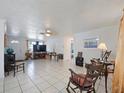 Bright living room with neutral walls, tile flooring, and a ceiling fan at 3338 Hoover Dr, Holiday, FL 34691