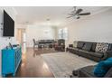 Open-concept living and dining area featuring hardwood floors, stylish furnishings, and plenty of natural light at 4145 Shrewbury Pl, Land O Lakes, FL 34638