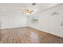 Bright and airy living room features hardwood floors and a front door with a decorative window at 4220 Oakfield Ave, Holiday, FL 34691