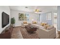 Bright living room with hardwood floors, neutral-toned furniture, a large window, and modern decor at 4220 Oakfield Ave, Holiday, FL 34691