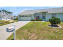 Inviting home with a two-car garage, lush lawn and a mailbox with the house number at 4301 Avanti Cir, New Port Richey, FL 34655