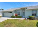 Charming single-story home with a well-manicured lawn and a light-colored exterior at 4301 Avanti Cir, New Port Richey, FL 34655