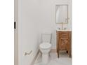 Elegant powder room featuring a wooden vanity with a marble countertop and gold fixtures at 4515 20Th N St, St Petersburg, FL 33714