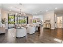 Spacious living room with hardwood floors, modern chandelier, and access to outdoor area at 481 W Davis Blvd, Tampa, FL 33606