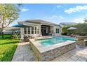 Resort style private pool and spa with outdoor kitchen and beautifully landscaped backyard at 5903 Nature Ridge Ln, Lithia, FL 33547