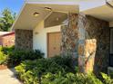 Inviting front entrance with a stone facade and well-maintained landscaping at 6703 Peachtree Dr, Temple Terrace, FL 33617