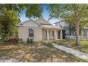 Inviting home with a cozy front porch, neutral exterior, and a well-maintained yard at 718 30Th N Ave, St Petersburg, FL 33704