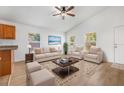 Bright living room features wood floors, ceiling fan, and ample seating for a comfortable and inviting feel at 718 30Th N Ave, St Petersburg, FL 33704