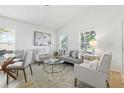 Bright living room with hardwood floors, vaulted ceilings, and modern furniture at 718 30Th N Ave, St Petersburg, FL 33704
