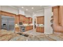 Spacious kitchen boasts custom wood cabinets, stainless steel appliances, and granite countertops at 729 Manns Harbor Drive, Apollo Beach, FL 33572
